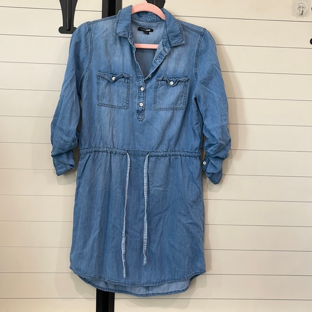 Light denim dress. Sleeves can roll up and button or leave down. Ties at waist